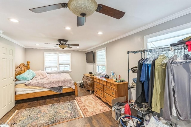 bedroom with crown molding, ceiling fan, and dark wood-type flooring