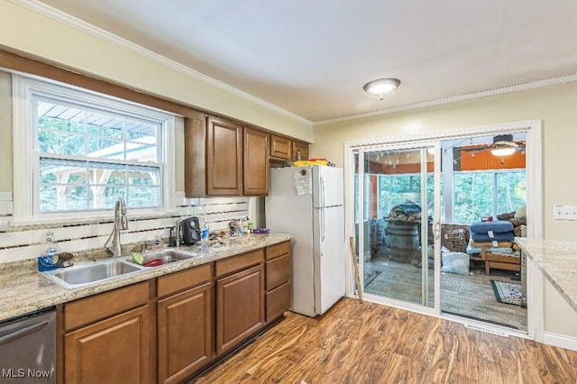 kitchen featuring decorative backsplash, white fridge, stainless steel dishwasher, and light wood-type flooring