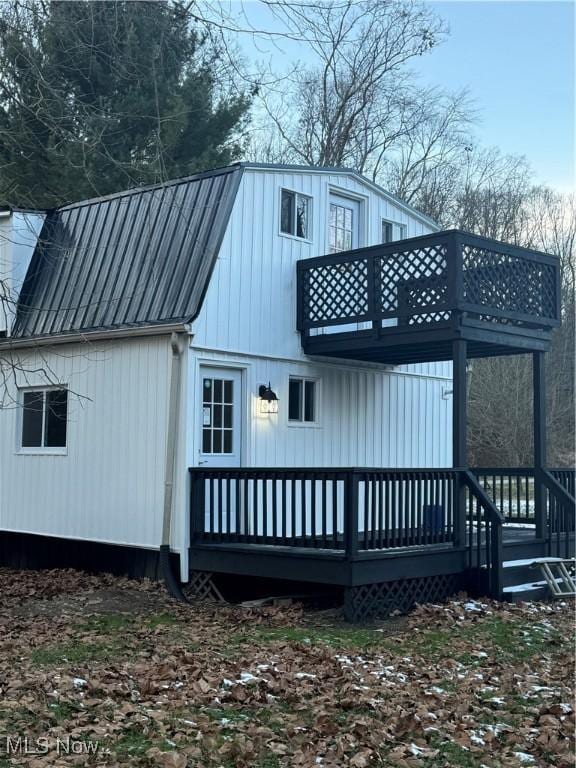 back of property with a balcony