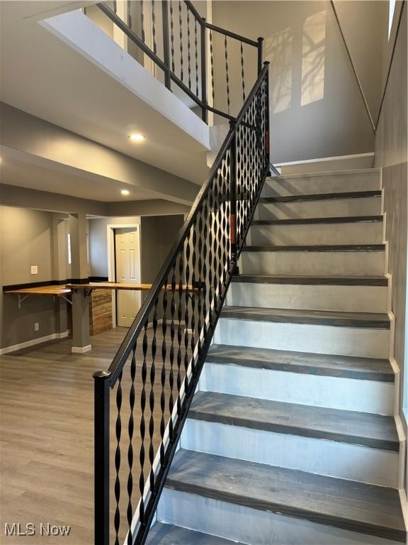 stairway featuring hardwood / wood-style flooring