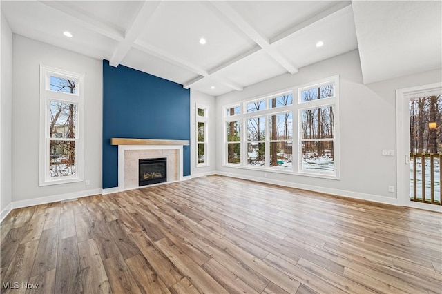 unfurnished living room with plenty of natural light and light hardwood / wood-style flooring