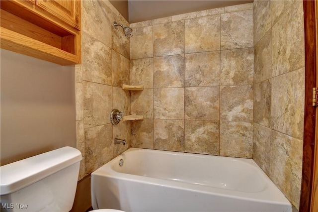 bathroom featuring tiled shower / bath combo and toilet