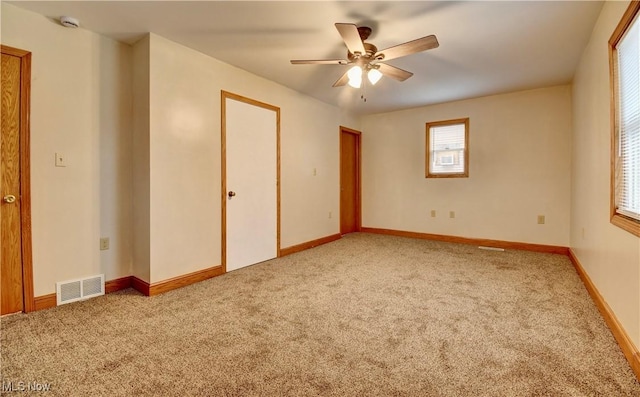 unfurnished bedroom with ceiling fan and light carpet