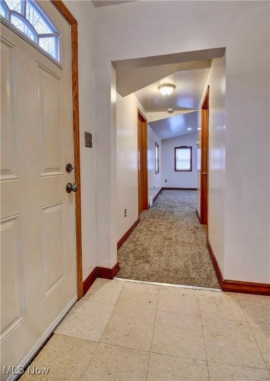 tiled entryway featuring lofted ceiling