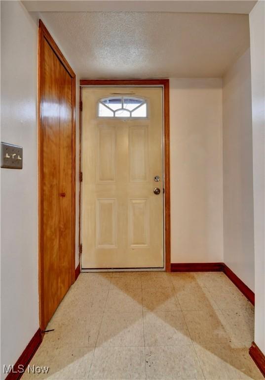 doorway featuring a textured ceiling