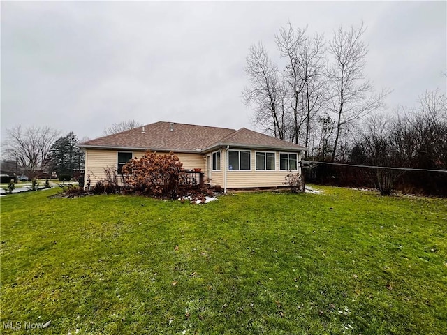 rear view of property featuring a yard