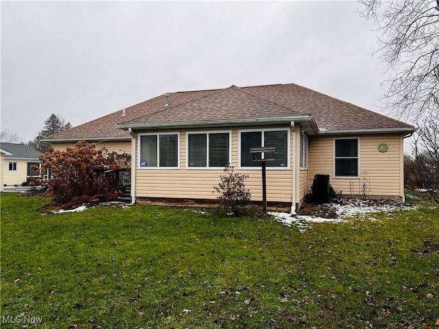 rear view of property with a lawn