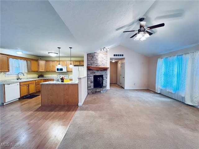 kitchen with a wealth of natural light, white appliances, hanging light fixtures, and lofted ceiling