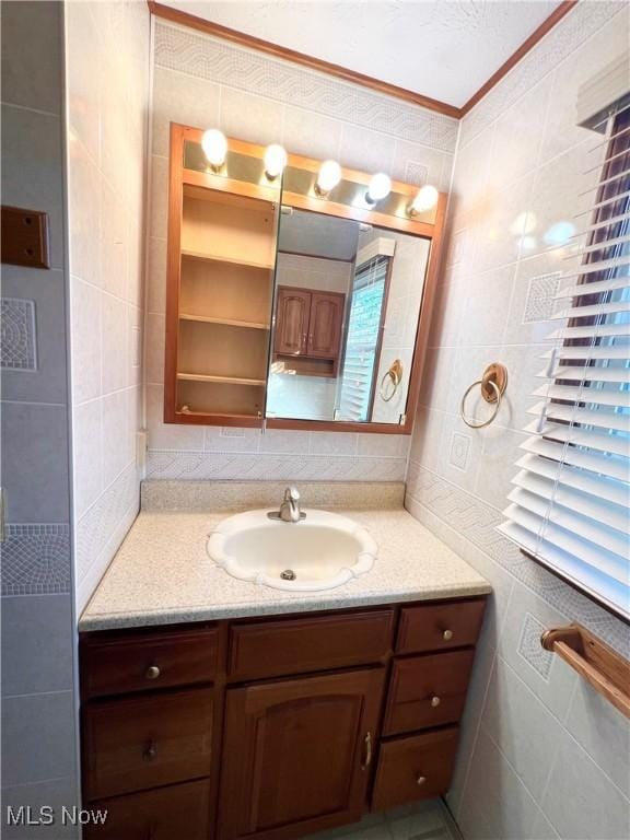 bathroom with vanity, tile walls, and crown molding