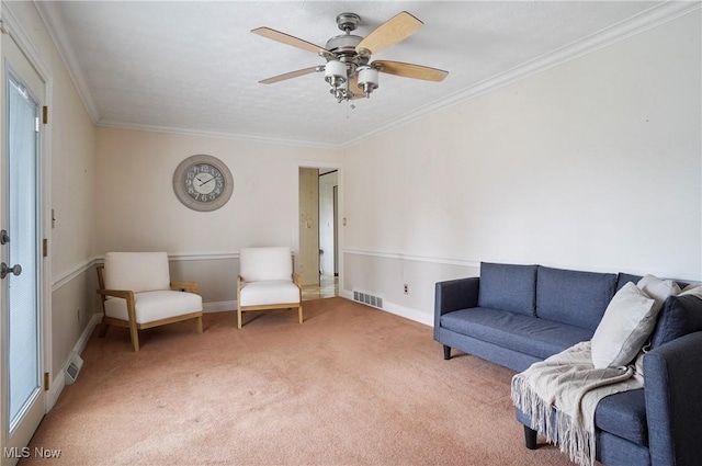 sitting room featuring crown molding, ceiling fan, and carpet flooring