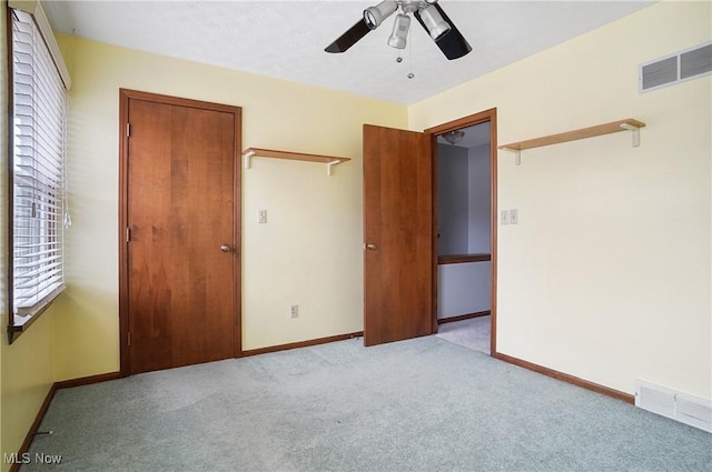 unfurnished bedroom featuring ceiling fan and light colored carpet