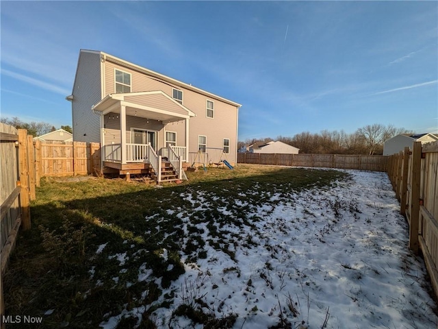 rear view of house featuring a lawn and a wooden deck