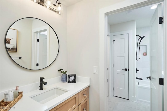 bathroom with tile patterned flooring, vanity, and tub / shower combination