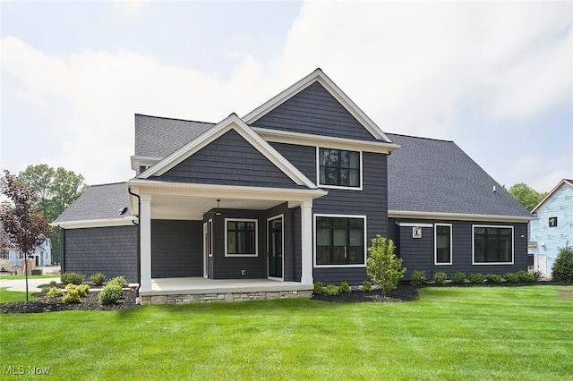 view of front of house with a porch and a front yard