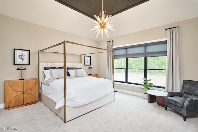 bedroom featuring a notable chandelier and carpet floors