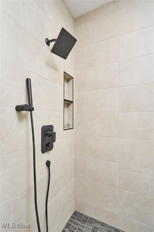 bathroom with a tile shower