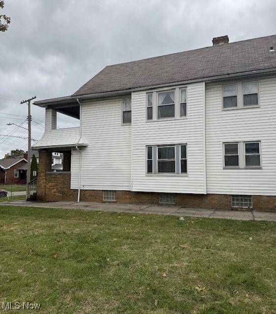 view of side of home with a lawn