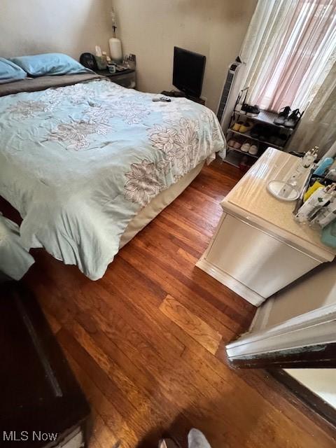 bedroom with hardwood / wood-style floors