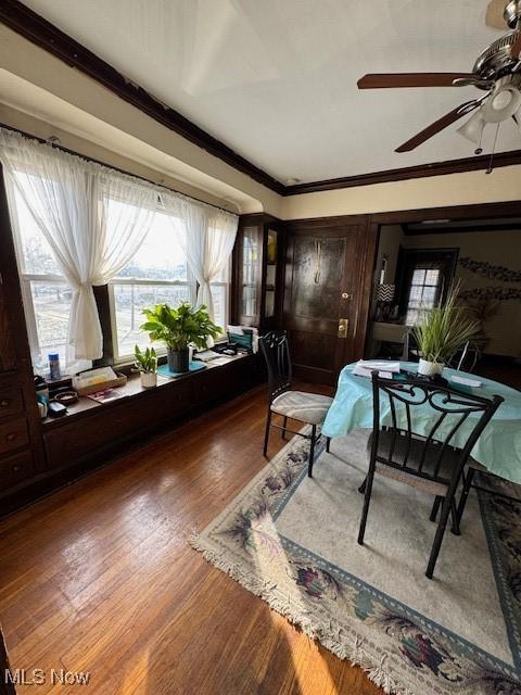 dining room with ceiling fan, crown molding, and wood-type flooring