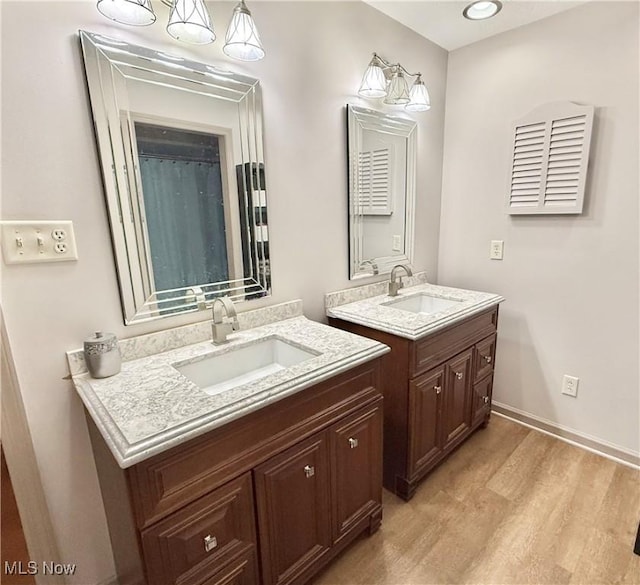 bathroom with vanity and wood-type flooring