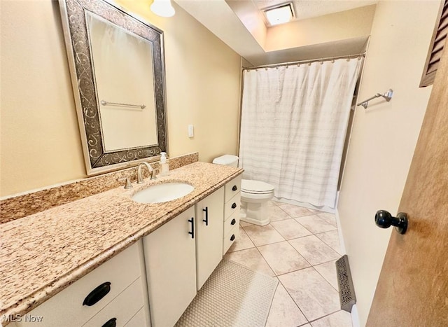 bathroom featuring tile patterned flooring, a shower with curtain, vanity, and toilet