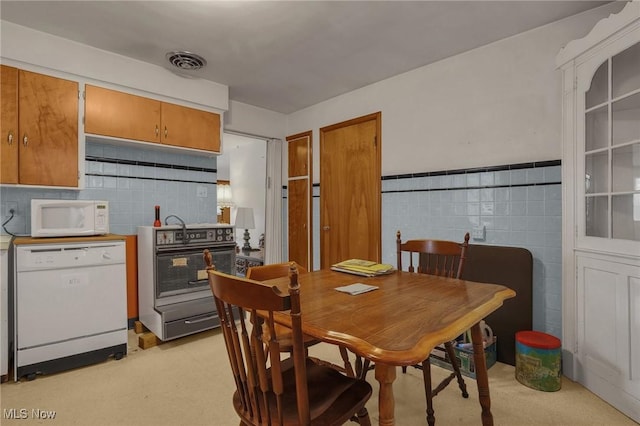 1956 Bluff Ave, Columbus, OH 43212 - dining area featuring light carpet and tile walls
