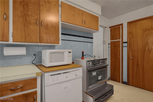1956 Bluff Ave, Columbus, OH 43212 - kitchen with white appliances, light countertops, backsplash, and brown cabinets