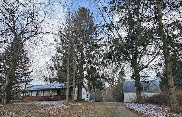 view of side of property with covered porch