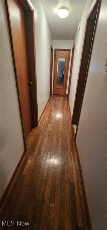 hallway with dark wood-type flooring