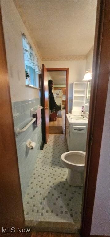 bathroom with tile patterned flooring, toilet, and sink