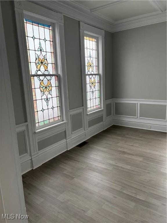 934 Main St, Wellsville, OH 43968 - empty room with ornamental molding, a decorative wall, wood finished floors, and a wainscoted wall