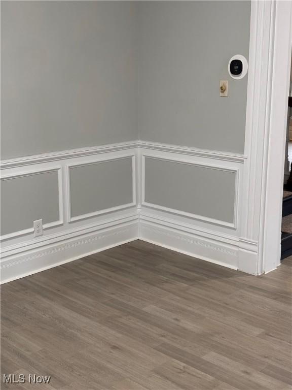 934 Main St, Wellsville, OH 43968 - spare room with a decorative wall, wood finished floors, and wainscoting
