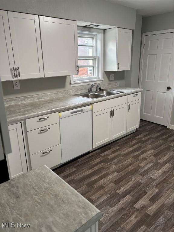 934 Main St, Wellsville, OH 43968 - kitchen featuring white dishwasher, dark wood finished floors, white cabinets, and light countertops