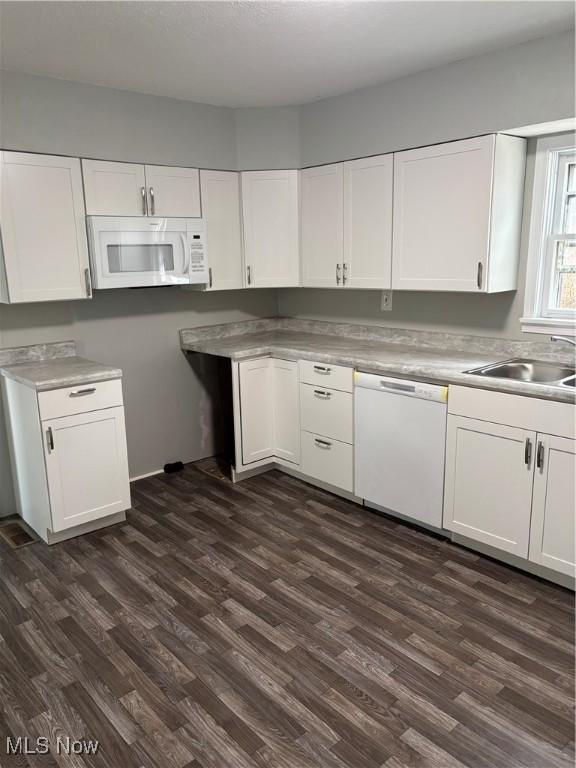 934 Main St, Wellsville, OH 43968 - kitchen with white appliances, white cabinets, and dark wood finished floors