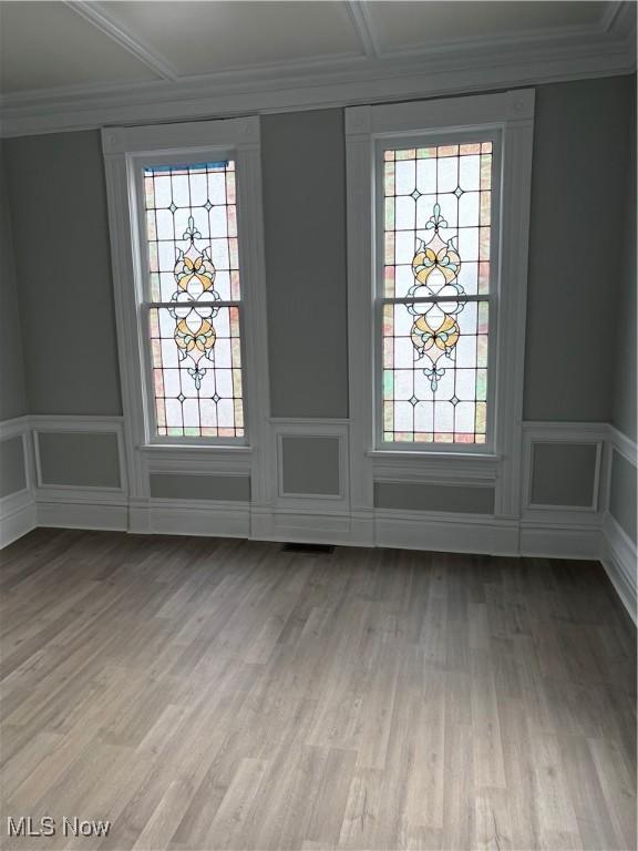 934 Main St, Wellsville, OH 43968 - entrance foyer with light wood finished floors, healthy amount of natural light, a decorative wall, a wainscoted wall, and ornamental molding