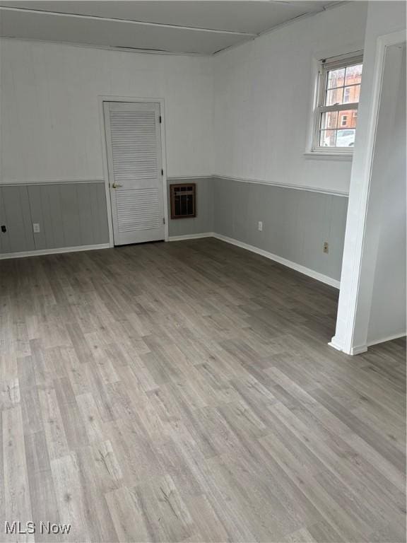 934 Main St, Wellsville, OH 43968 - empty room featuring wood finished floors and a wainscoted wall