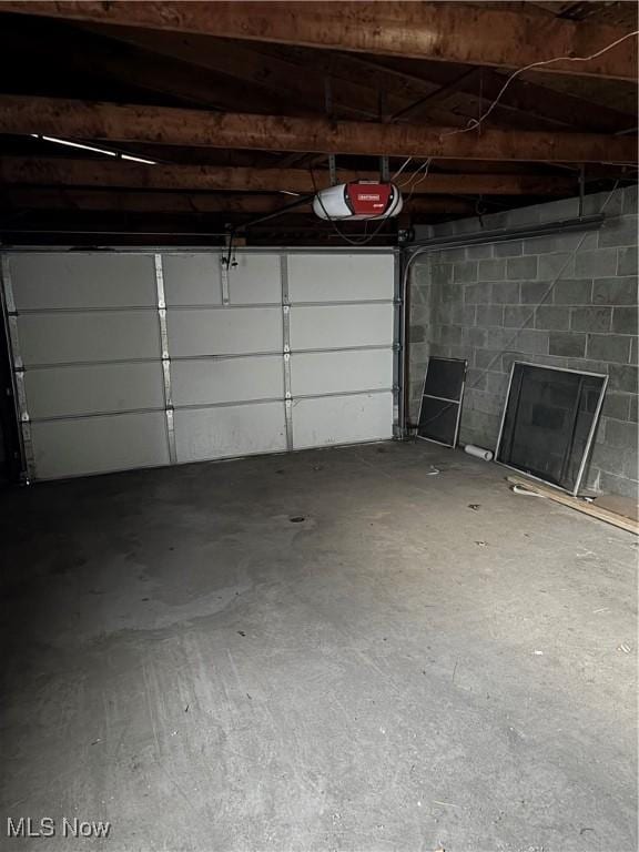 934 Main St, Wellsville, OH 43968 - garage featuring a garage door opener and concrete block wall