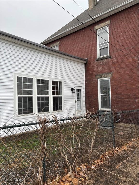 934 Main St, Wellsville, OH 43968 - back of property featuring brick siding and a chimney