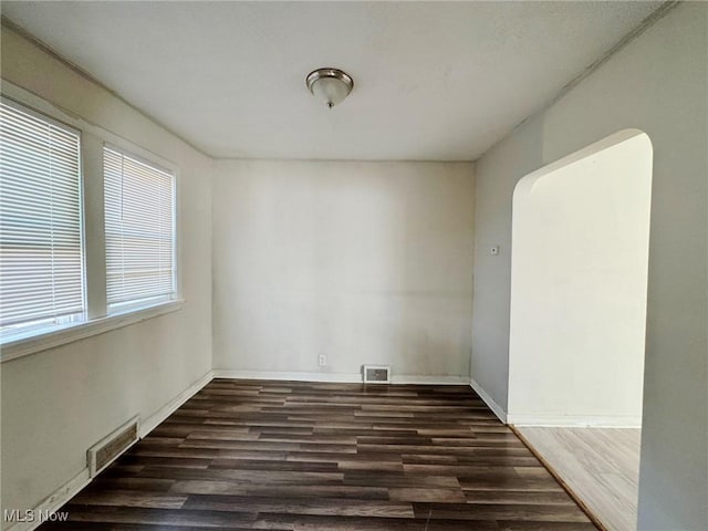 empty room with dark hardwood / wood-style floors