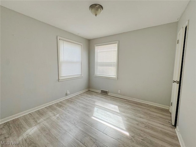 unfurnished room featuring light hardwood / wood-style flooring