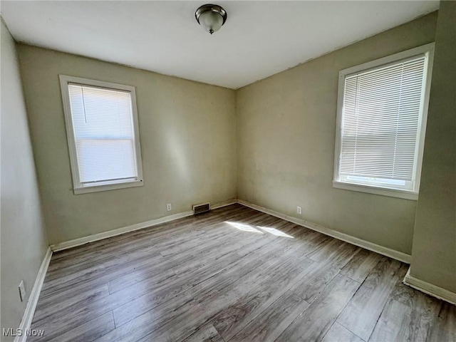 empty room with a healthy amount of sunlight and light wood-type flooring