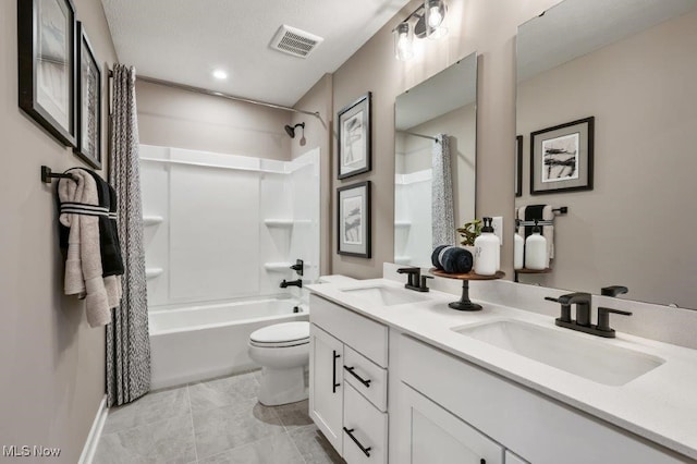 full bathroom featuring vanity, shower / bath combo, and toilet