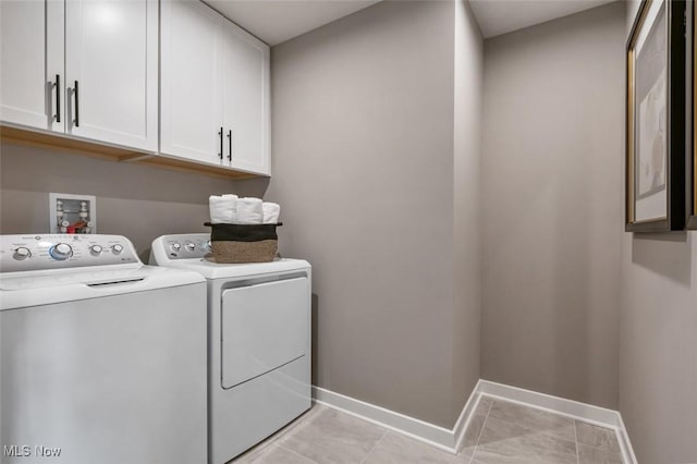 clothes washing area featuring cabinets, independent washer and dryer, and light tile patterned flooring