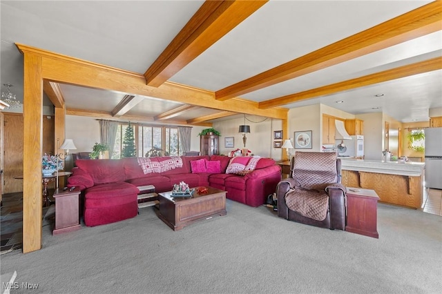 carpeted living room featuring beam ceiling