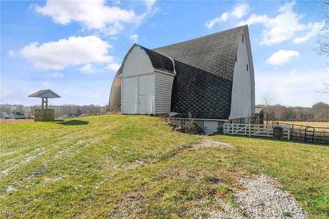 view of side of home with a yard