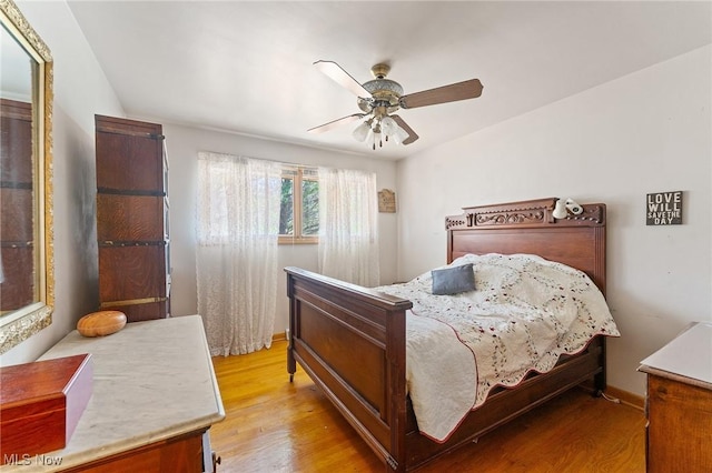 bedroom featuring light wood-type flooring and ceiling fan