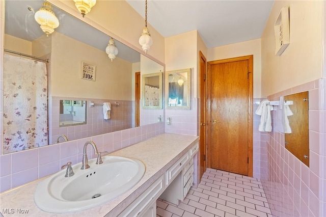 bathroom with tile patterned flooring, vanity, and tile walls