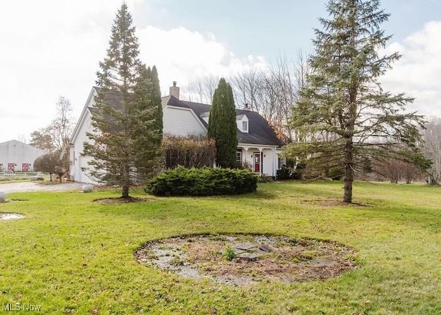 view of property exterior featuring a lawn