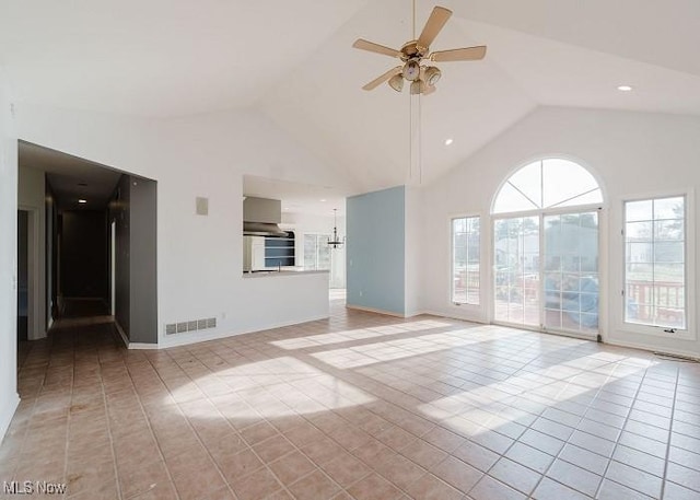 unfurnished living room with ceiling fan, light tile patterned floors, and high vaulted ceiling