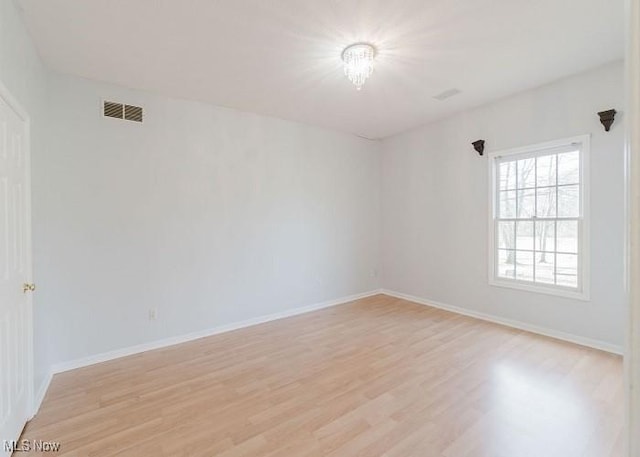 unfurnished room with light wood-type flooring